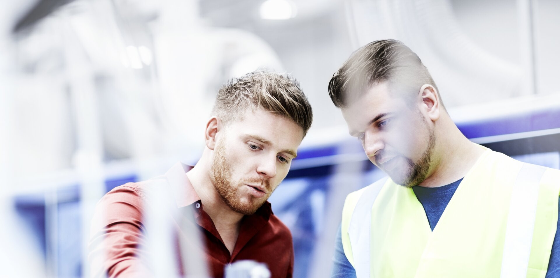 © iStock-535474757_stocknroll (Young manager and foreman looking at machine on production line)